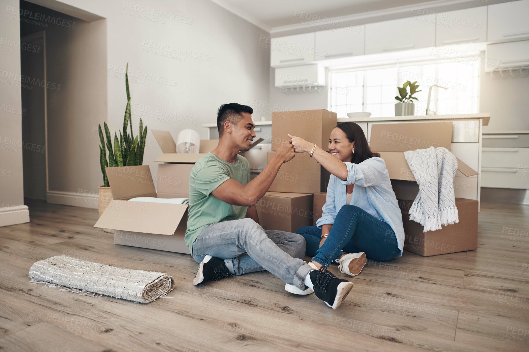 Buy stock photo Young couple, celebrate and moving to new home with boxes for renovation, investment or relocation. Happy, man and woman in living room excited for apartment together, property rent and mortgage loan