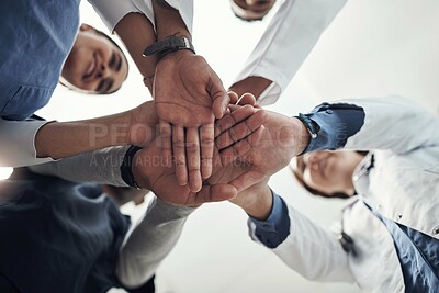 Buy stock photo Low angle, hands and stack with doctors, hospital and cooperation with teamwork, support and healthcare. Below, medical and professional with group, collaboration and schedule with goals and trust