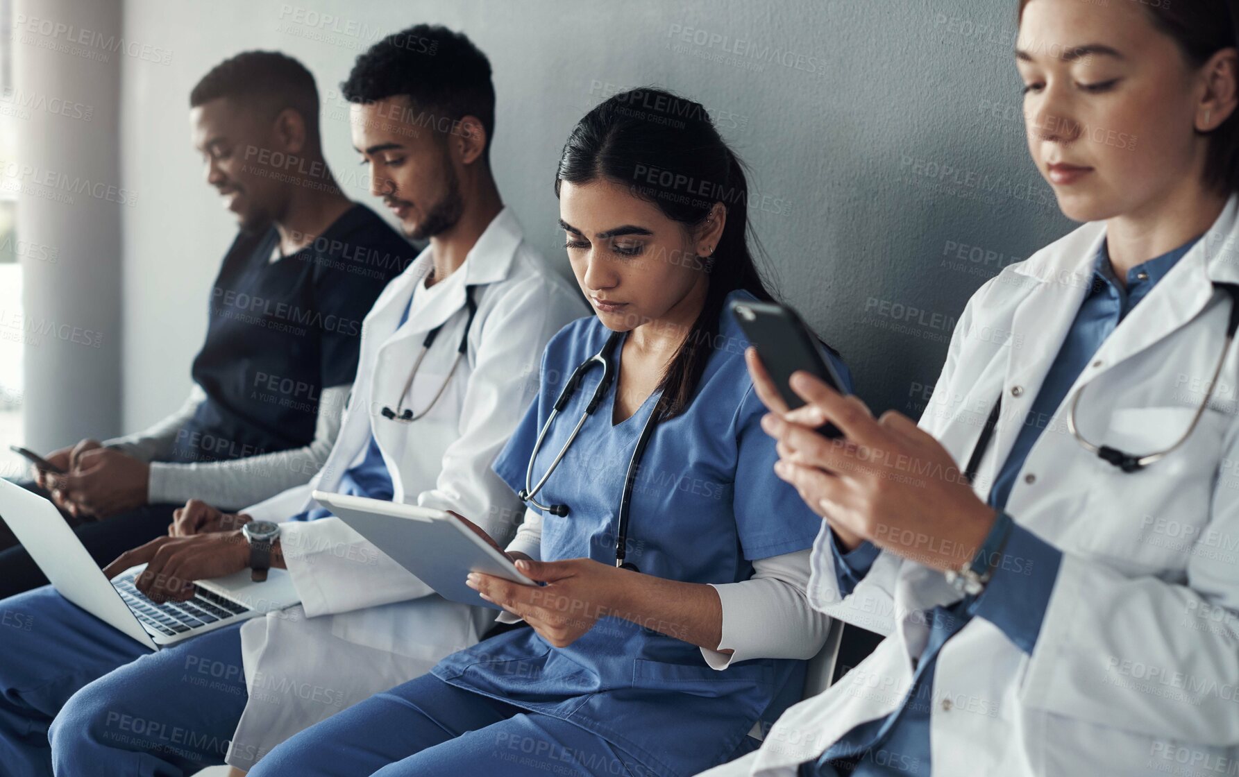 Buy stock photo Chairs, team and technology with doctors by wall for interview or public health conference and training meeting. People, medical staff and line for patient rounds or daily briefing, review and online