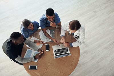 Doctor, teamwork and planning in meeting with computer, documents and training for medical residency in top view. Healthcare people, nurse and group leader with online research or solution for clinic