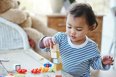 Buy stock photo Baby girl, table and playing with blocks or toys for playful time, chilldhood or development at home. Little child or cute toddler enjoying youth and stacking cubes, squares or building at house