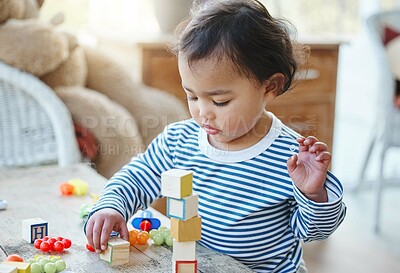Buy stock photo Games, toddler and toys in house, cute and growth with development of child, curious and building blocks. Childhood, baby and fun for girl in home, youth and adorable in weekend, hand and learning