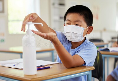 Buy stock photo Covid, hand sanitizer and school student with mask cleaning, protecting and staying safe in education classroom. Small, little and cute asian boy in learning in study class preventing spread of virus