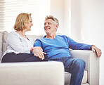 Happy mature couple relaxing together on a sofa at home