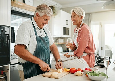 Buy stock photo A happy senior couple, cooking healthy food in kitchen and drinking champaign as they enjoy retirement. Elderly woman with sitting on counter, man with silver laughing and they smile in love together