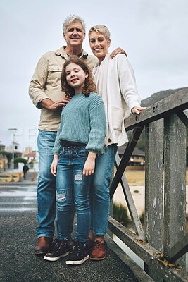 Buy stock photo Portrait, child and grandparents on a bridge in a park for adventure, walking and happiness together. Happy, smile and young girl with senior and elderly people on family walk in nature during winter