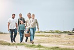 Big family, happy and walking for a picnic on holiday, vacation or weekend trip outdoors for relaxing and bonding. Mother, father and grandma travel with old man and girl child to enjoy quality time