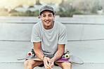 Young man, skateboard and skater with music at urban skate park, youth and recreation with earphones for audio streaming. Happy, portrait, and gen z outdoor with skating practice and fitness.