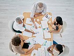 Team work, hands or creative business people in a meeting planning a logo, branding or marketing color on paper. Designers, top view or employees working with senior manager on strategy or kpi goals