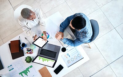 Buy stock photo Top view, business people and laptop for web design at desk with teamwork, blank tablet and marketing. Man, woman and planning for ux with chart, data analytics and collaboration at tech startup