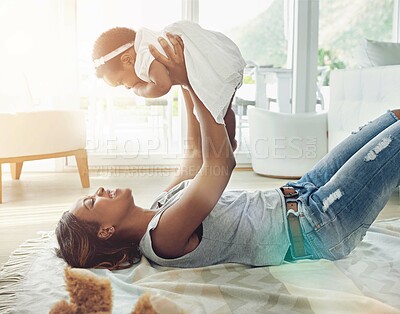 Buy stock photo Happy woman, baby and lifting for childhood development, motor skills and bonding as family in lounge. Mother, daughter and home for love, support or growth in parenting with joy, smile and memory