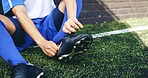 Hands, person and ready with sneakers on soccer field of game warm up, preparation and sports challenge. Athlete, tie and shoes for football competition, fitness performance and tournament training
