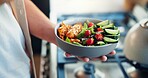 Hand, bowl and salad in kitchen, home and meal prep for eating, meat or flavor with vegetables. Person, chef and dish with food for nutrition, wellness and gut health with diet choice at apartment