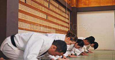 Buy stock photo Bow, respect and people in martial arts studio for practice, training or self defense class. Culture, karate and group of students with greeting or etiquette gesture to master in dojo for honor.