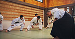 Bow, martial arts and people in class, fitness and respect for dojo, training and sensei with students. Aikido, master and group with discipline, learn and teaching of self defense, fighter and Japan