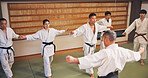Martial arts, master and Japanese people with learning, exercise and karate etiquette in dojo. Japan, combat training and fight studio with sport, discipline and warrior in taekwondo class in gym