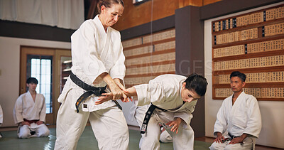Buy stock photo Karate, martial arts and self defense with teacher in dojo for demonstration, fitness or training. Challenge, learning or technique with Sensei and student people in Japan for combat or fighting