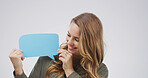 Smile, speech bubble and woman in studio, feedback or announcement on white background. Billboard, person or model with poster, communication or opinion with voice review, information sign or showing