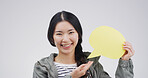 Portrait, speech bubble and Asian woman in studio, smile and social media on white background. Review, person and model with branding space, communication or about us with feedback, opinion or mockup