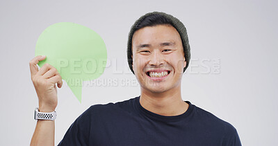 Buy stock photo Speech bubble, mockup space and portrait of man in studio for announcement, opinion or voice. Happy, social media and Asian male person with text board, blank sign or placard vote by white background