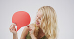 Smile, woman and icon with speech bubble in studio for announcement, news and signage. Mockup space, person and poster for advertising brand, show information and billboard forum in white background