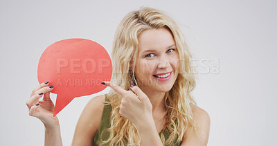 Buy stock photo Happy woman, speech bubble and point in studio, portrait and mock up space on white background. Person, smile and blank poster for feedback, announcement and choice with social media in Germany
