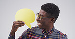 Happy, black man and social media with speech bubble in studio for chat on a white background. Male person, feedback or model with smile, icon or shape for quote, conversation or say on mockup space
