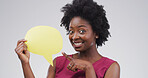 Black woman, speech bubble and point with smile, studio portrait and mockup space on white background. Person, sign and blank poster for announcement, feedback and choice for social media in Nigeria