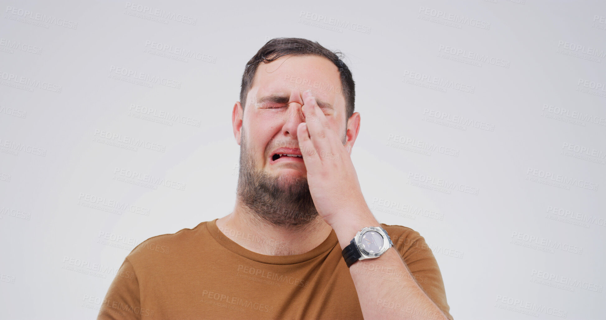Buy stock photo Man, crying and sad in studio with depression, grief or loss with emotional reaction on white background. Space, tears and crisis with male person in mourning, distress with mental health and unhappy