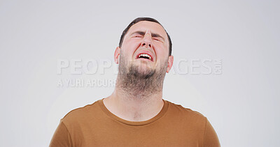 Buy stock photo Sad, depression and man crying in studio for grief, stress or disaster on white background with space. Anxiety, unhappy and person with mental health crisis, bad news and mourning with loneliness
