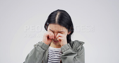 Buy stock photo Woman, crying and mental health in studio with grief, wipe tears or stress for loss on white background. Person, depression and mock up space with broken heart, frustrated and anxiety with trauma