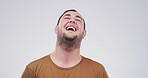 Laugh, happy and face of man in studio with funny joke, humor and comedy on white background. Emoji, confidence and isolated person with laughter for positive attitude, cheerful and joy for comic
