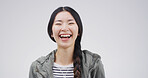 Laughing, student and Asian woman with pride, portrait or smile for opportunity to learn and studio. White background, happy or person with reaction to funny joke, humor and scholarship in university