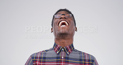 Buy stock photo Portrait, smile and laugh with black man in studio for funny story, joke and reaction to meme. Happy, male person and humor with positive attitude, good mood and silly expression on white background