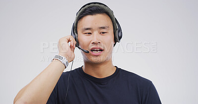 Buy stock photo Man, talking and headset in studio for telemarketing, sales pitch and insurance advice in call center. Agent, tech and communication on white background for consultation, business contact us and CRM