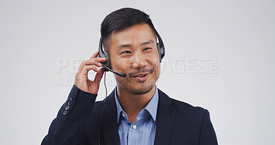 Buy stock photo Customer service, agent and talking on headset in studio for inbound inquiry, help or assistance. Mockup, asian man or call center support for product knowledge, FAQ or contact us on white background