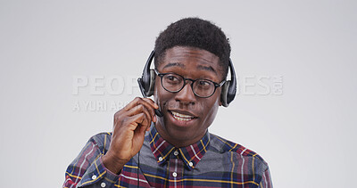 Buy stock photo Call center agent, studio and black man listening for tech support, glasses and customer service. IT consultant, headset and communication for virtual problem solving, contact us and white background