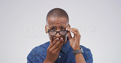 Buy stock photo Shocked, portrait and black man with glasses in studio for face expression, bad news or mistake. Omg, shame and cover mouth for gossip, frown and embarrassed or fear of fail on a white background