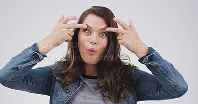 Buy stock photo Crazy, funny face and portrait of woman in studio with open eyes, silly and comic facial expression. Goofy, joke and female person from Canada with comedy gesture for humor by white background.