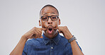 Portrait, funny face and black man in studio with goofy expression on white background. Silly, mouth and African person with crazy gesture, emoji and playful comedy with glasses for comic humor