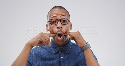 Buy stock photo Portrait, funny face and black man in studio with goofy expression on white background. Silly, mouth and African person with crazy gesture, emoji and playful comedy with glasses for comic humor