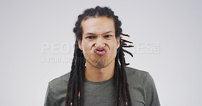 Buy stock photo Man, funny face or silly with expression or attitude for joke or comic on a white studio background. Male person, model or goofy humor with braids or pout for quirky personality or comedy on space