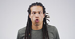 Goofy man, funny face or expression with attitude for joke or comic on a white studio background. Male person, model or humor with braids or pout for quirky personality or comedy on mockup space