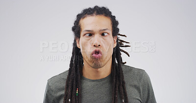 Buy stock photo Goofy man, funny face or expression with attitude for joke or comic on a white studio background. Male person, model or humor with braids or cross eyed for quirky personality or silly comedy on space