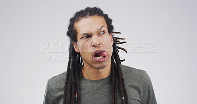 Buy stock photo Tongue out, silly and man in studio with funny face for emoji, comedy and playful humor. Mockup space, quirky and isolated person with joke, crazy and goofy expression on white background for meme