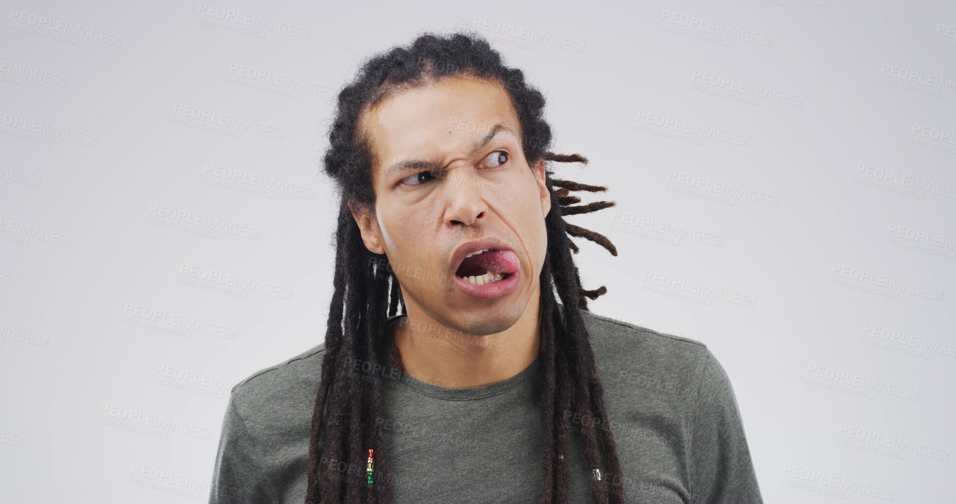 Buy stock photo Tongue out, silly and man in studio with funny face for emoji, comedy and playful humor. Mockup space, quirky and isolated person with joke, crazy and goofy expression on white background for meme