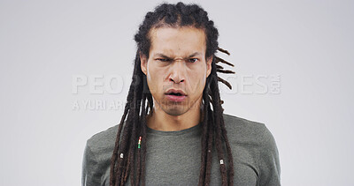Buy stock photo Serious, angry and portrait of man in studio with disappointed, frown and mad on white background. Mockup space, isolated and face of person with annoyed, frustrated and upset facial expression