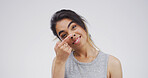 Cross eyes, silly and portrait of woman in studio with funny face for emoji, comedy and humor. Mockup space, happy and isolated person with funny face, crazy and goofy expression on white background