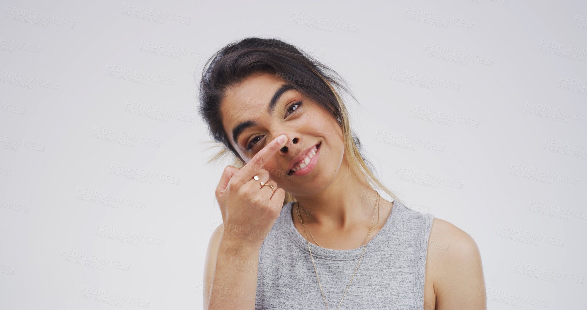 Buy stock photo Touch nose, silly and portrait of woman in studio with funny face for emoji, comedy and humor. Mockup space, happy and isolated person with quirky, crazy and goofy expression on white background