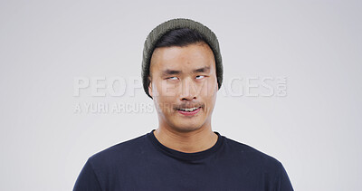 Buy stock photo Silly, rolling eyes and Asian man in studio with funny face for playful, comedy and humor on white background. Mockup space, emoji and isolated person with goofy, quirky and crazy facial expression